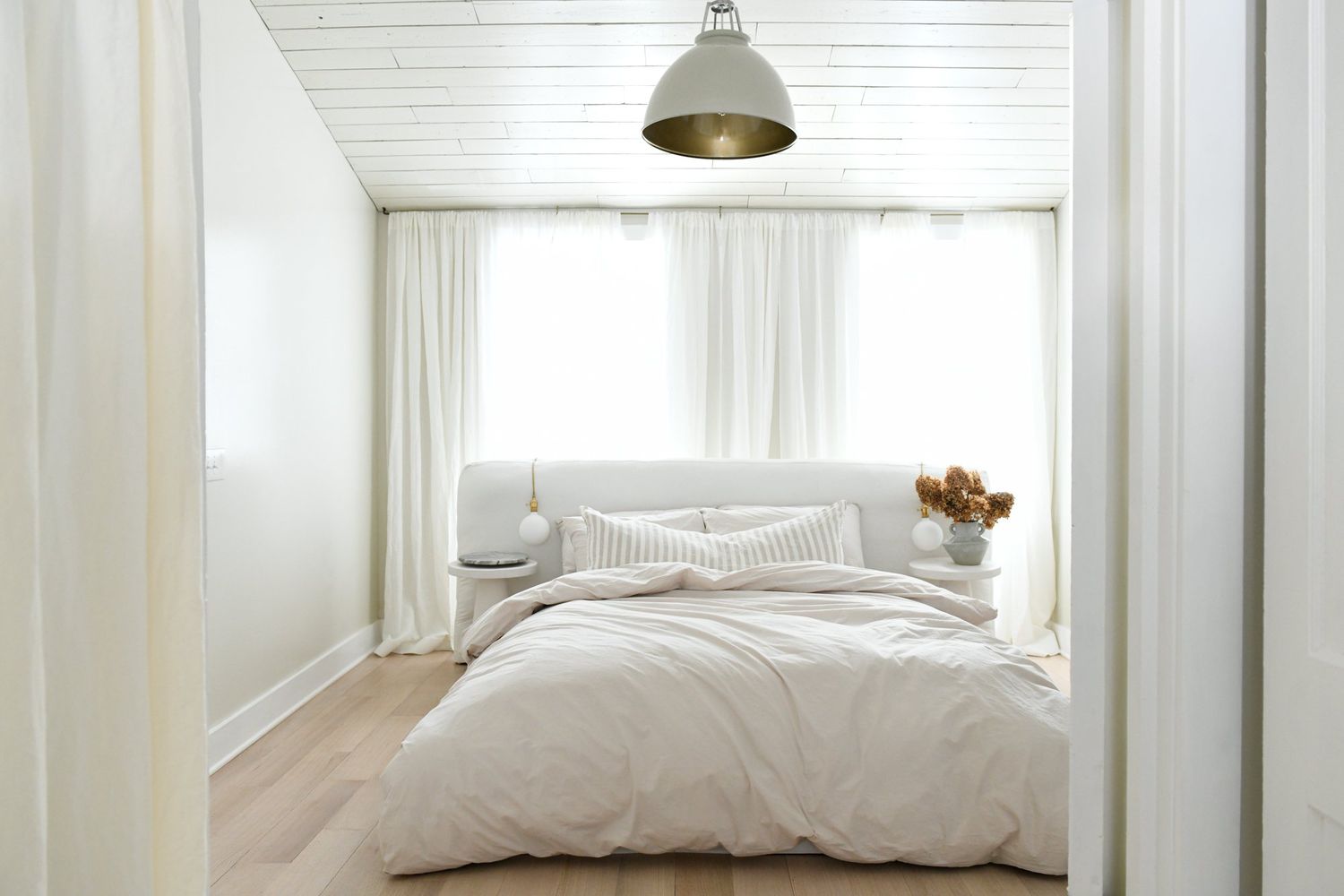 Ganz in Weiß gehaltenes minimalistisches Schlafzimmer