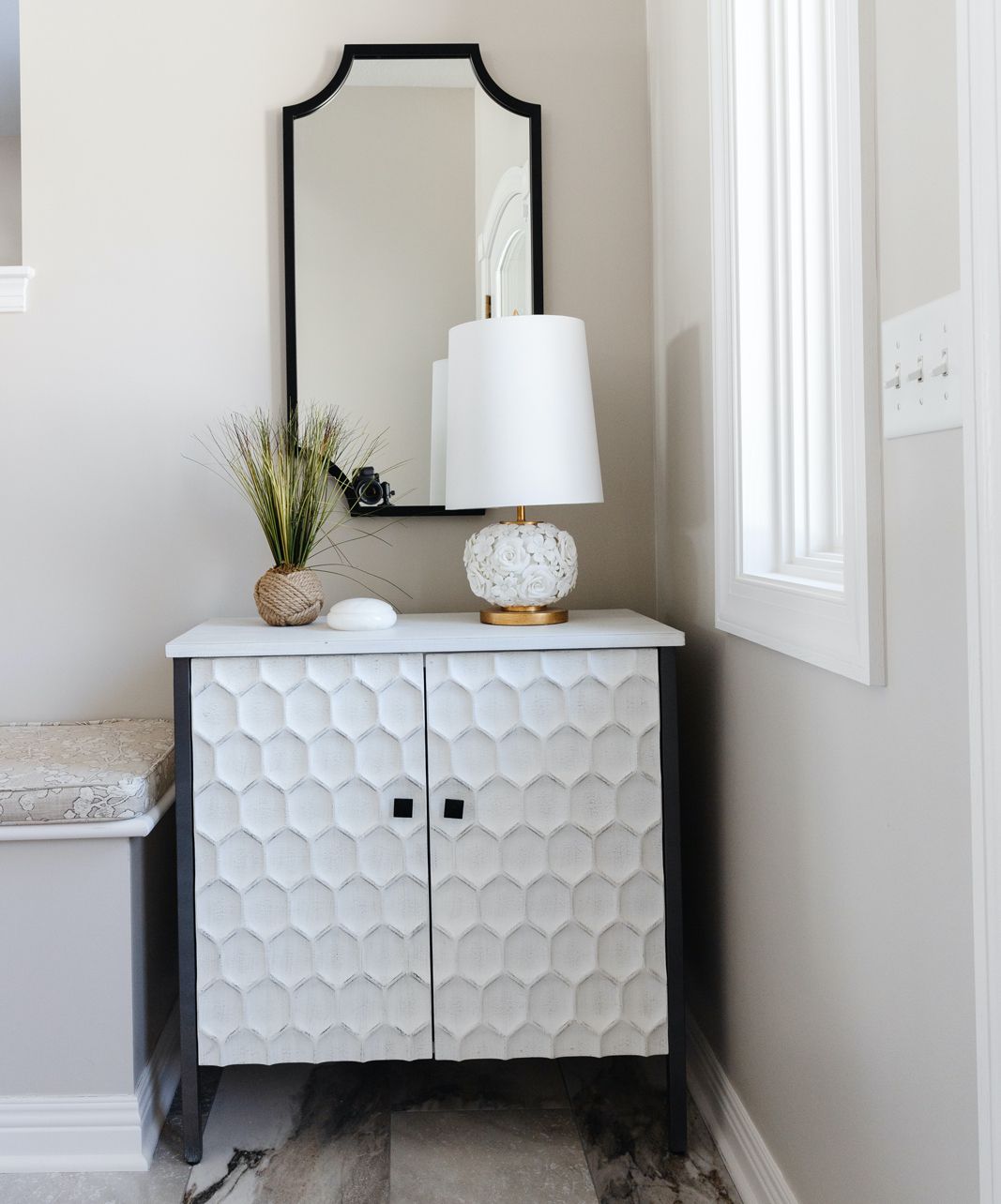 Entryway with a textured table lamp.