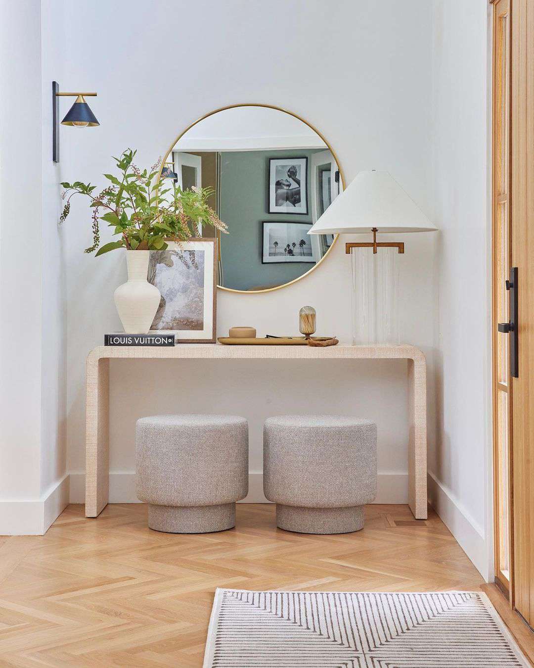 Entryway with a table lamp and wall sconce.