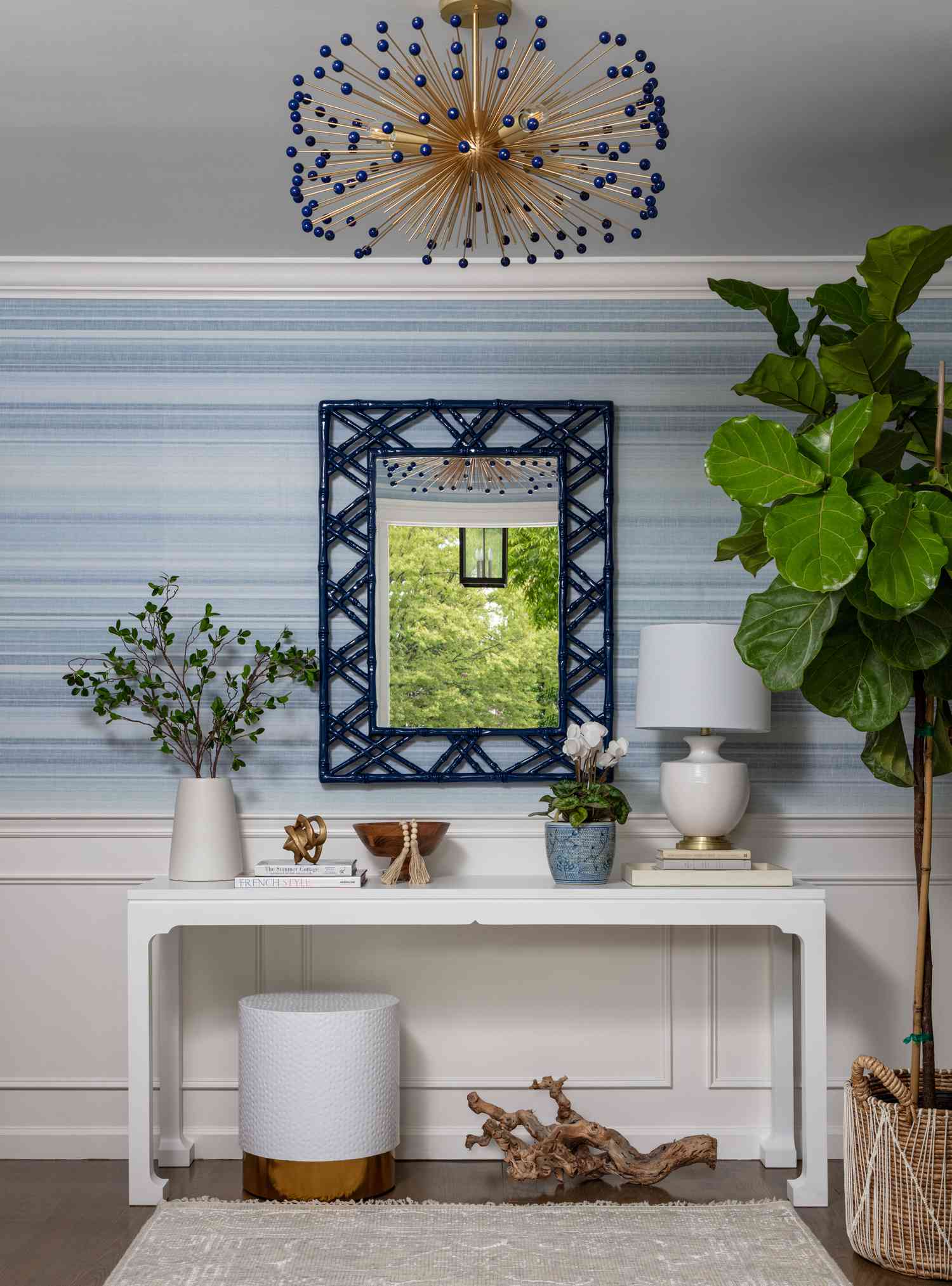 Entryway with a stylish mid century modern light fixture.