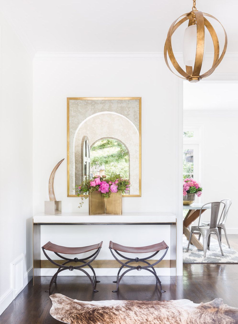 Glamorous entryway with a rustic glam light fixture.