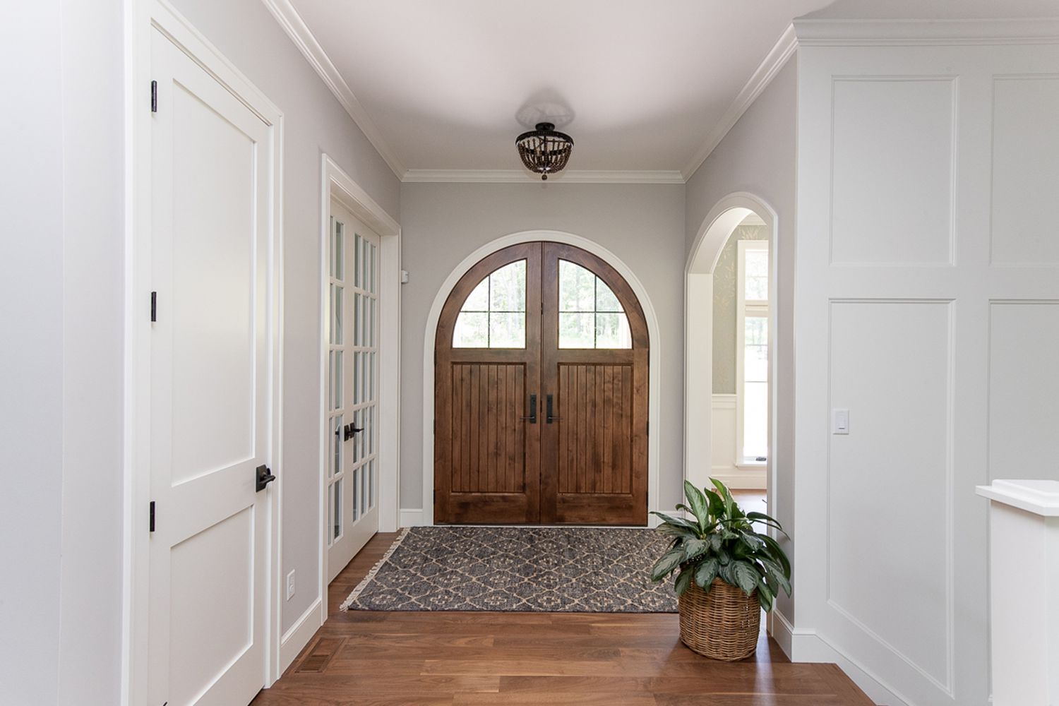 Entryway with beaded light fixture.