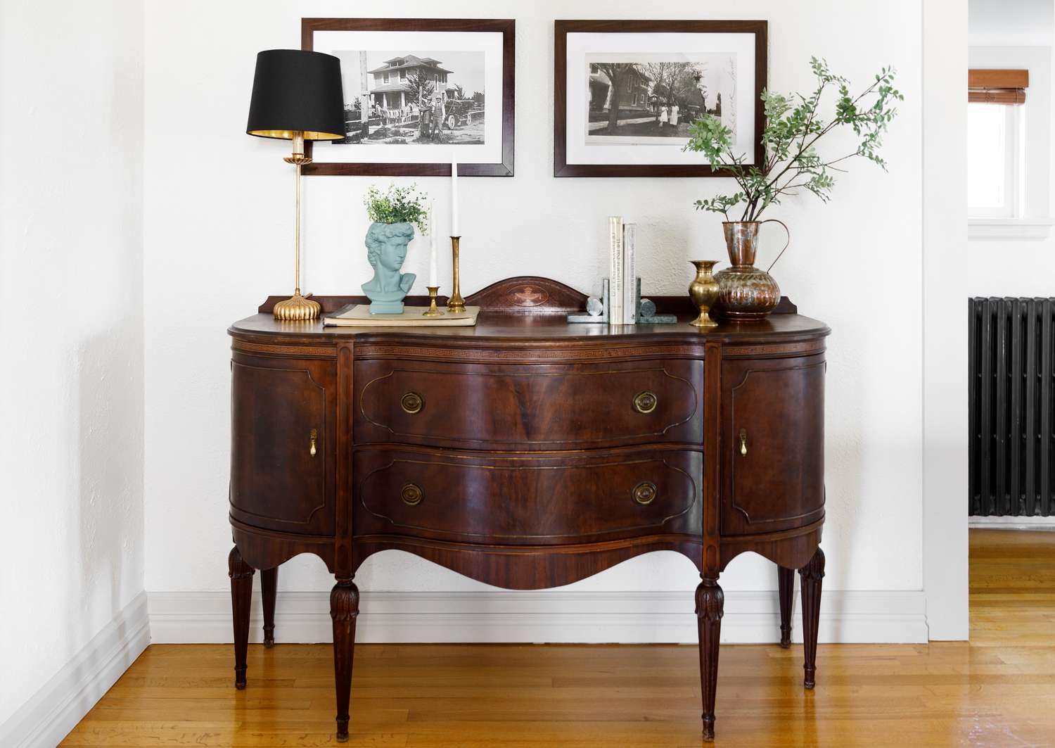 Holz-Sideboard mit Lampe und Zweigen