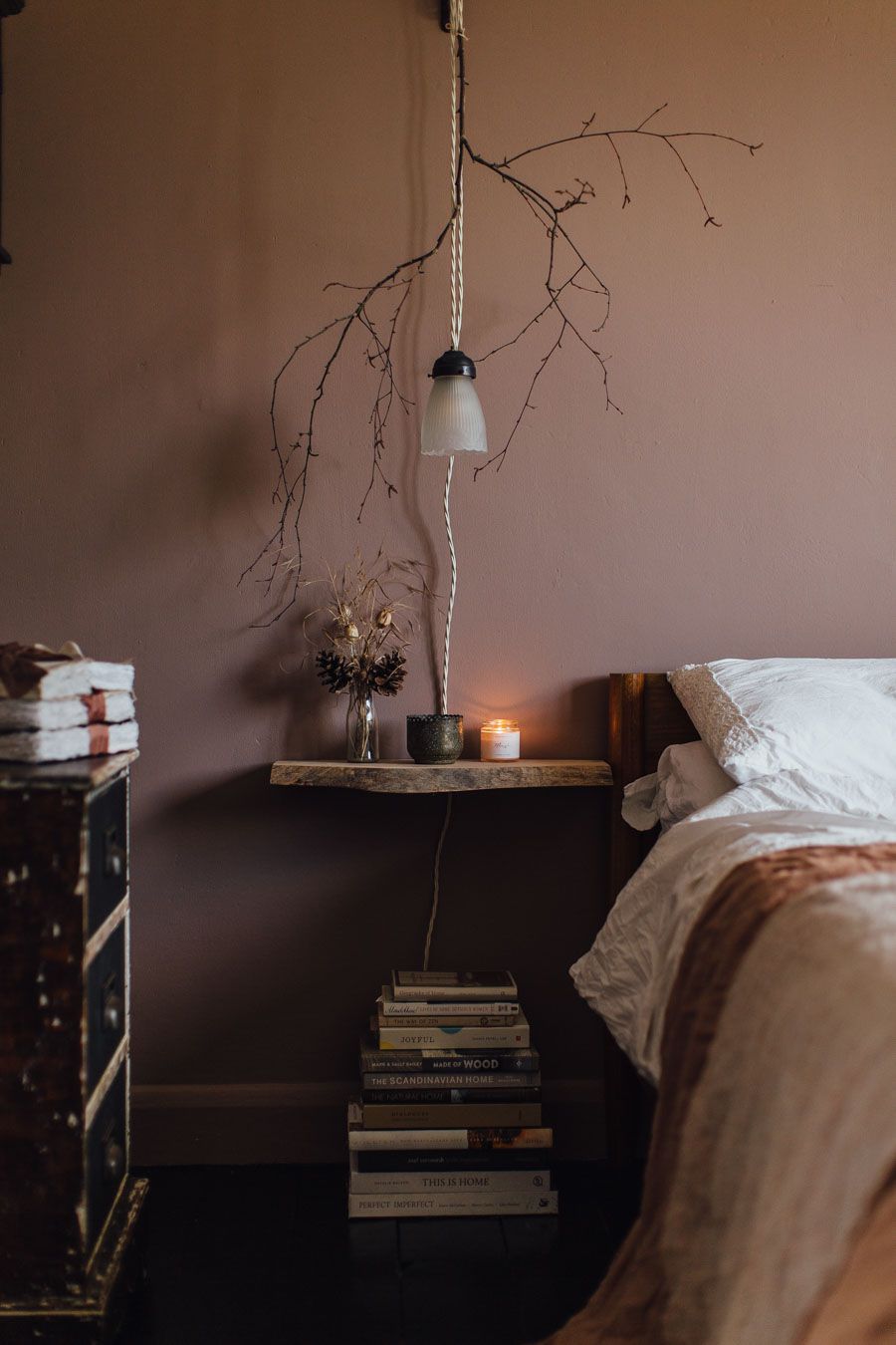 decorating over the bed with foraged branches