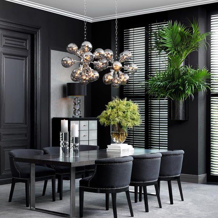 black dining room with green plants