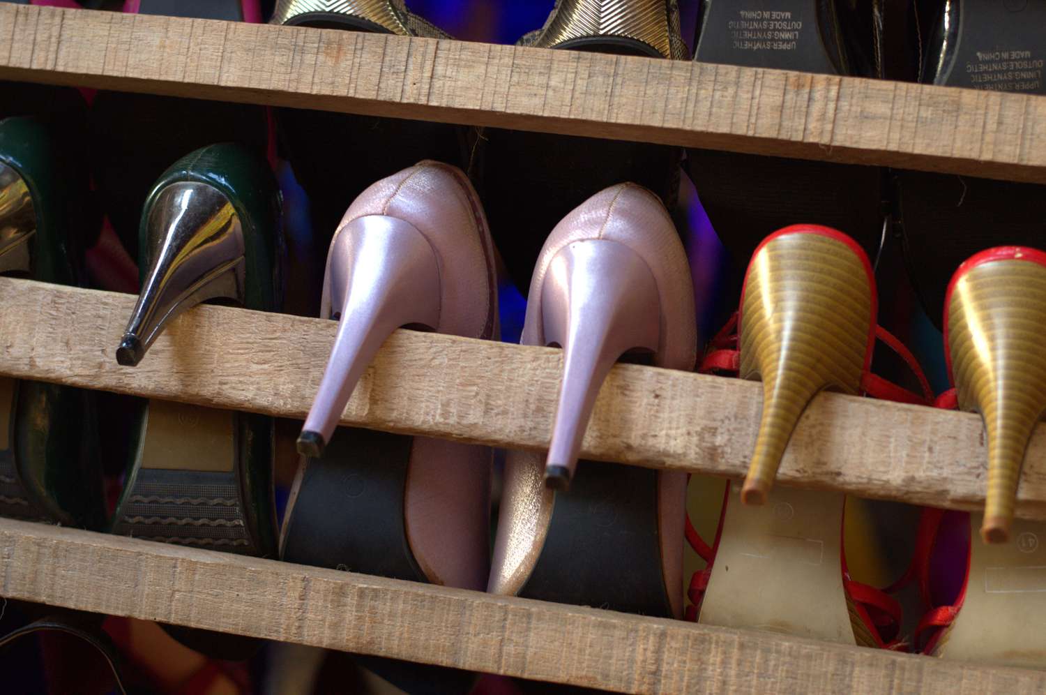 High heel shoes hanging from a wood pallet