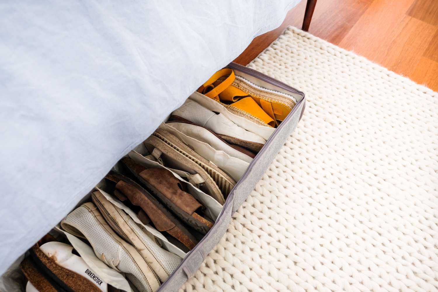 Storing shoes under the bed in a bin