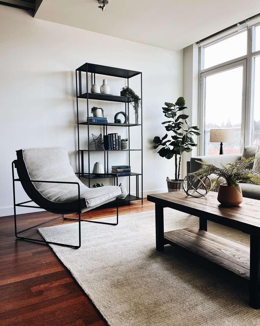 living room with industrial metal chair and shelving