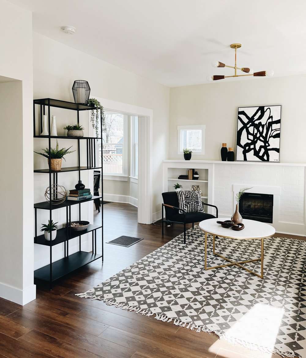 living room with metal shelving and chair