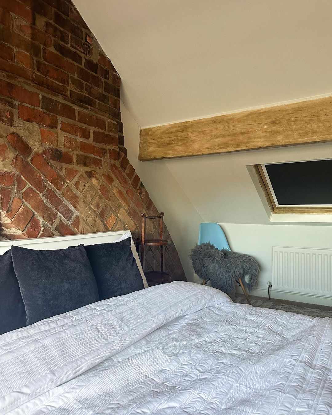 low ceiling bedroom with brick and beams