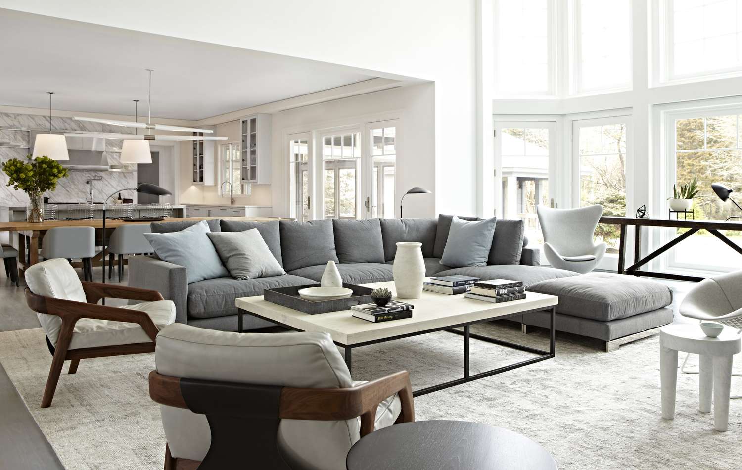 Modern living room with large sectional with kitchen in the background