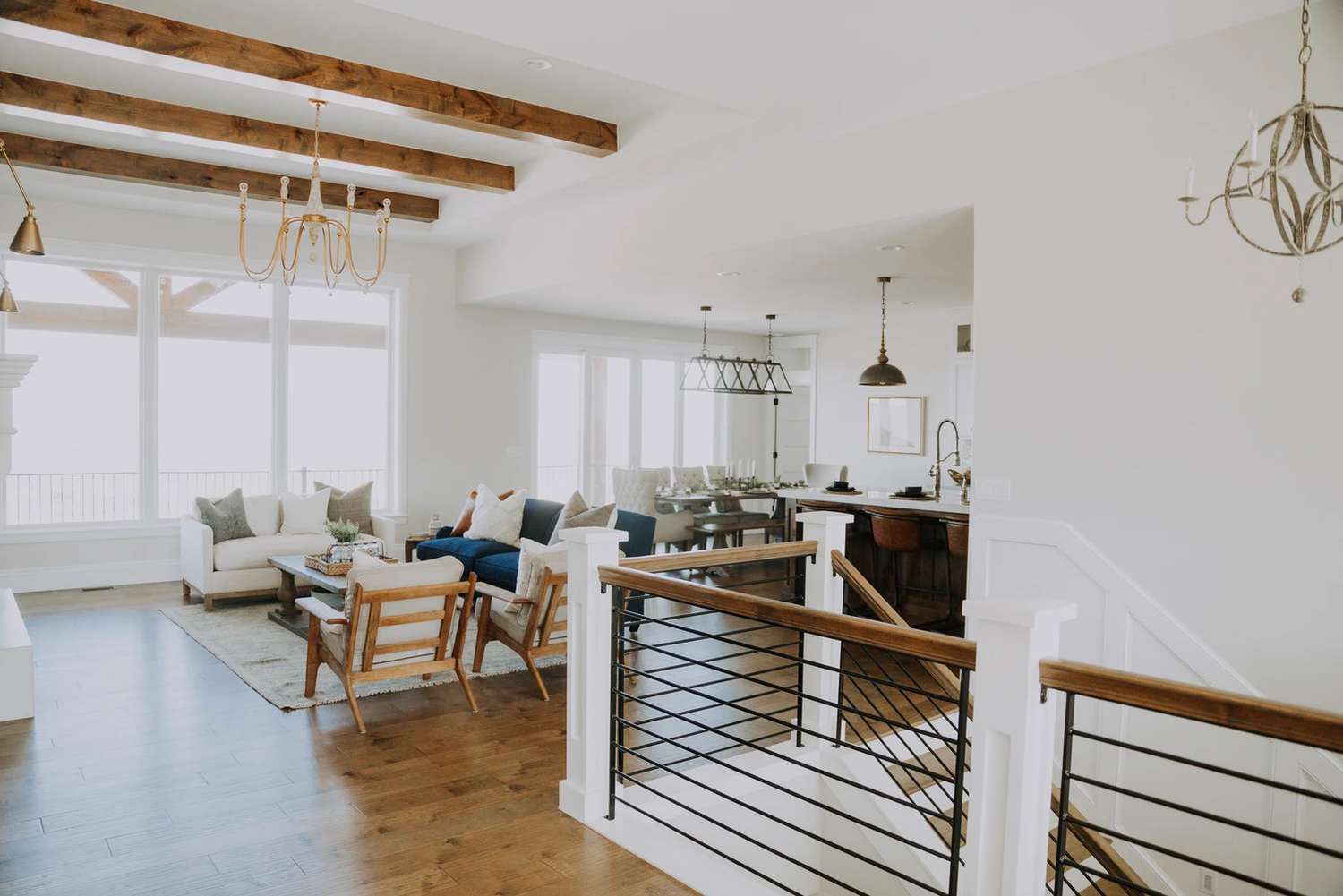 Living room next to a staircase with kitchen behind it