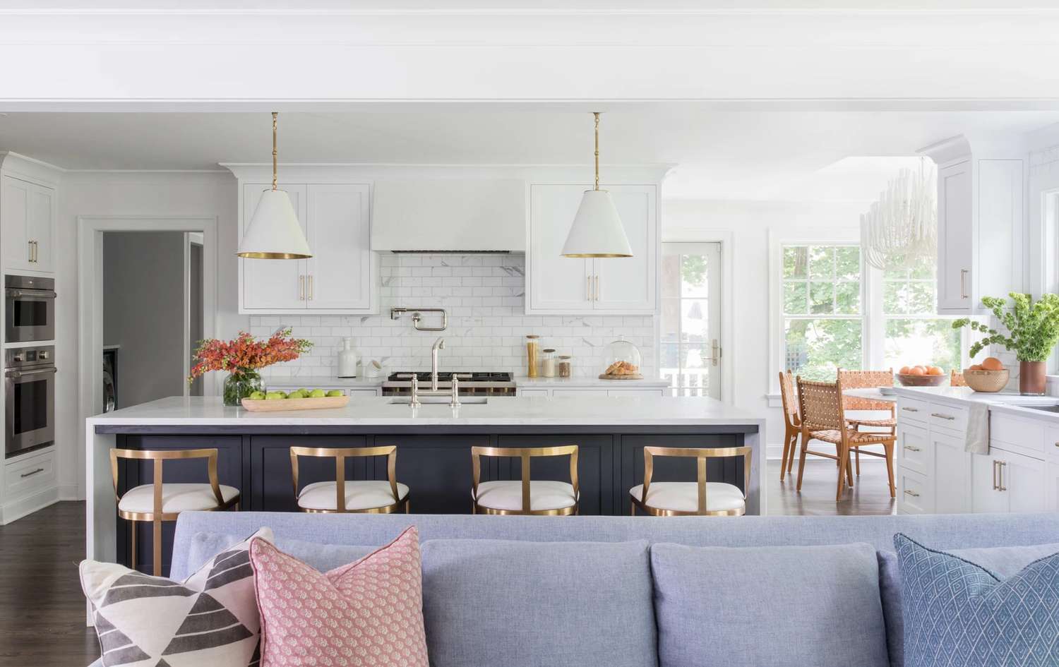 Kitchen with large island and a blue sofa in the living room