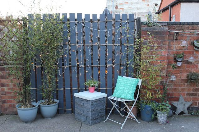 diy rustic garden screen with string lights