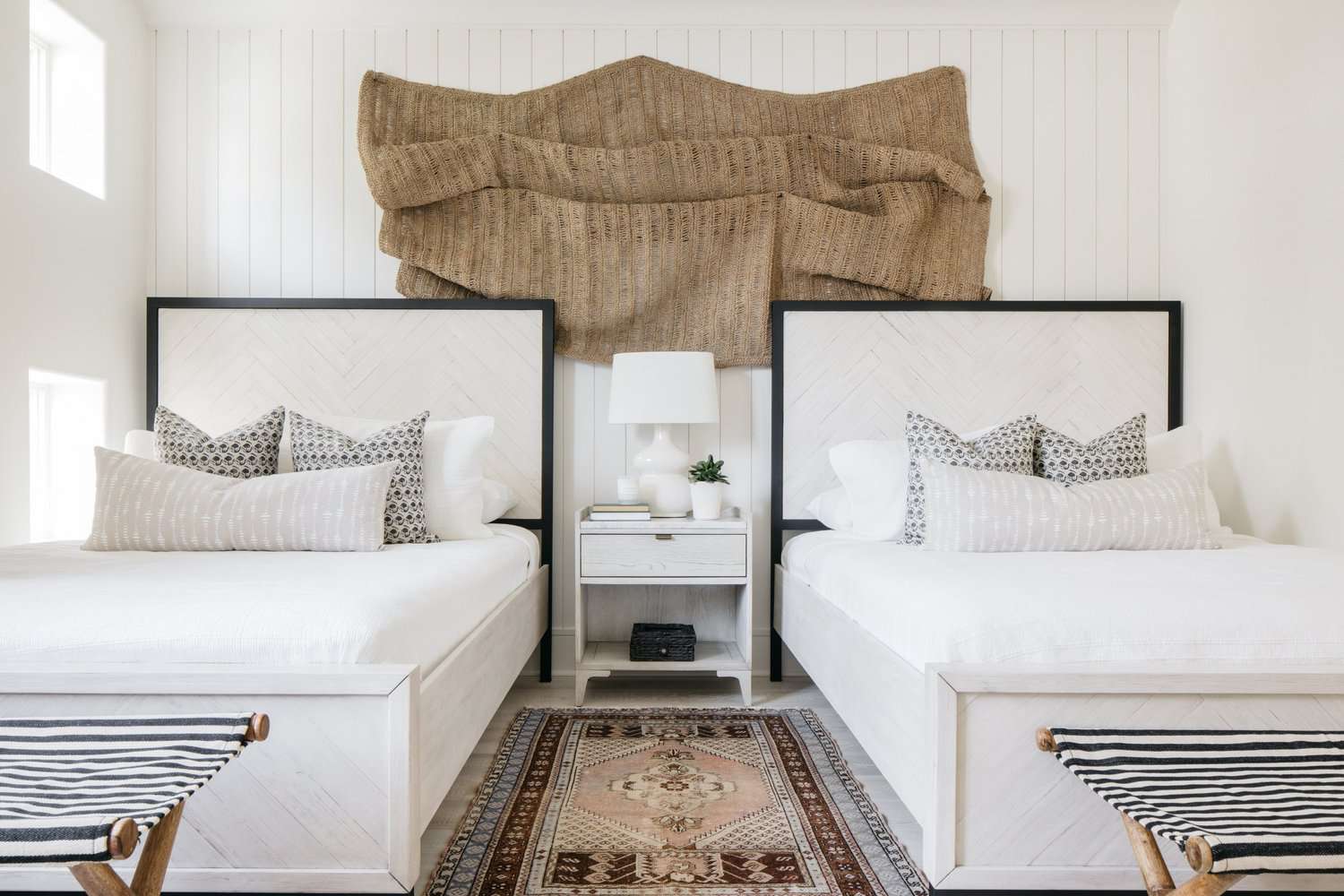 fabric wall hanging above the bed