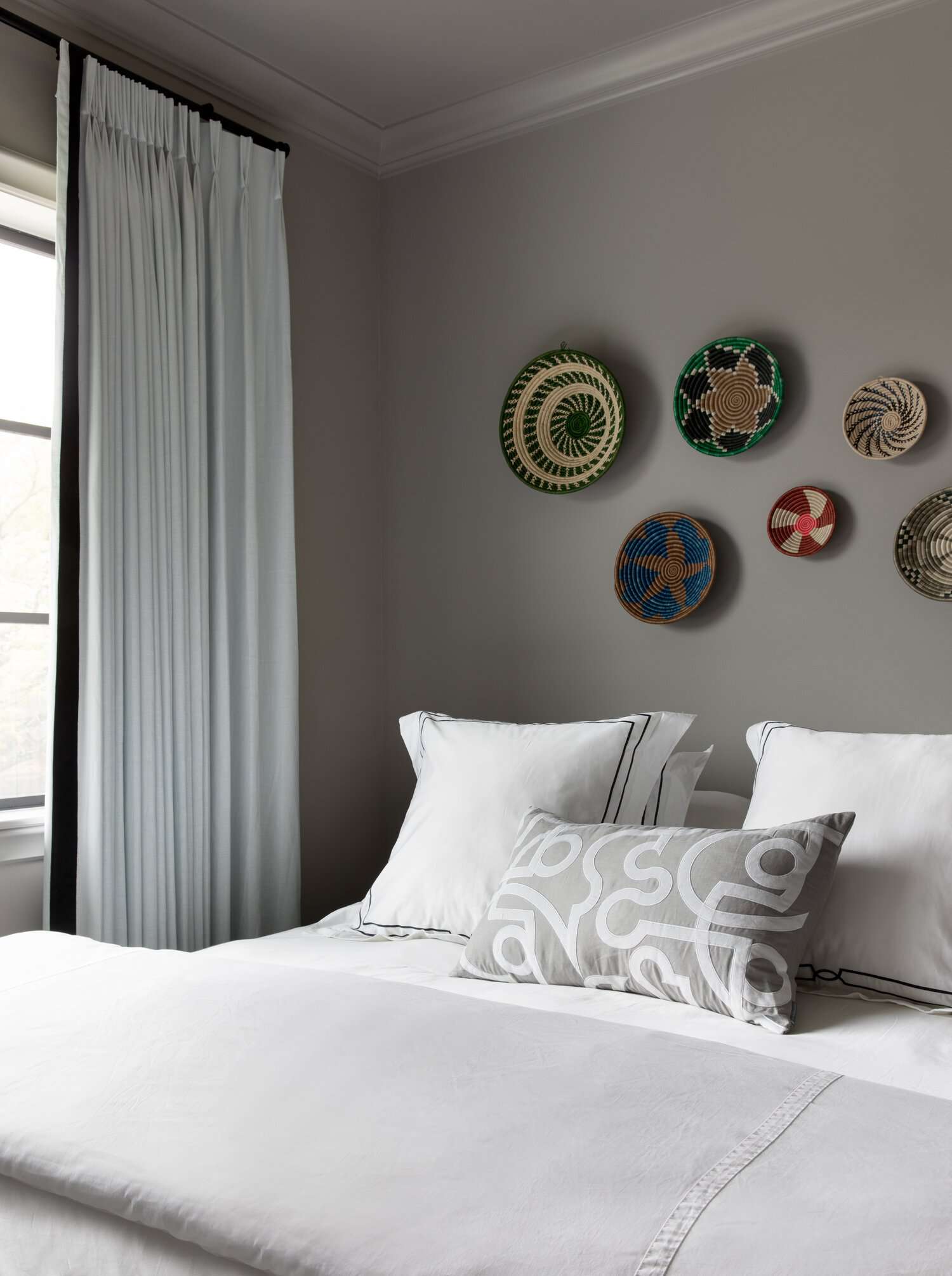 colorful wall baskets over bed