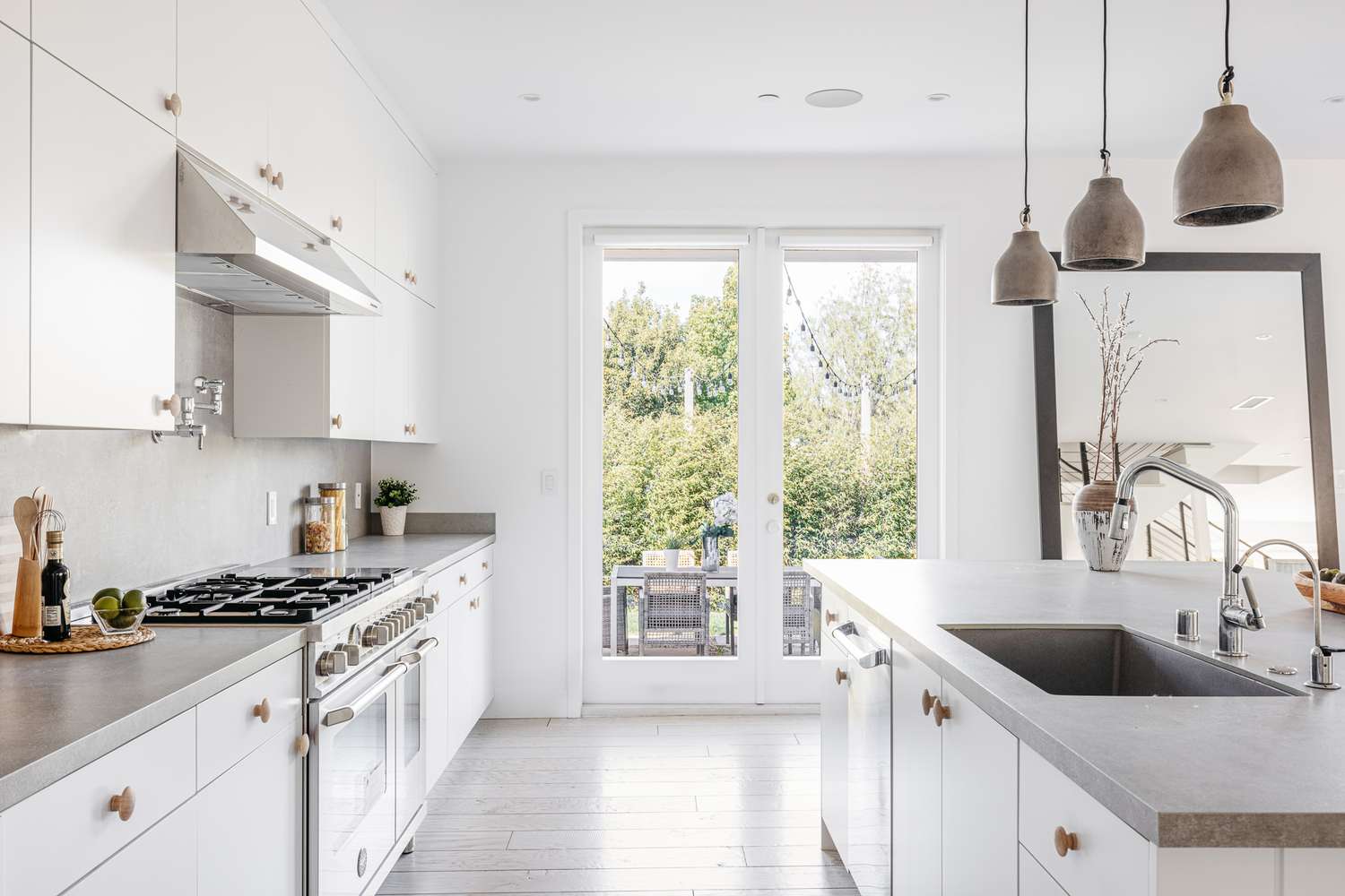 Bright kitchen with concrete countertops and glass doors