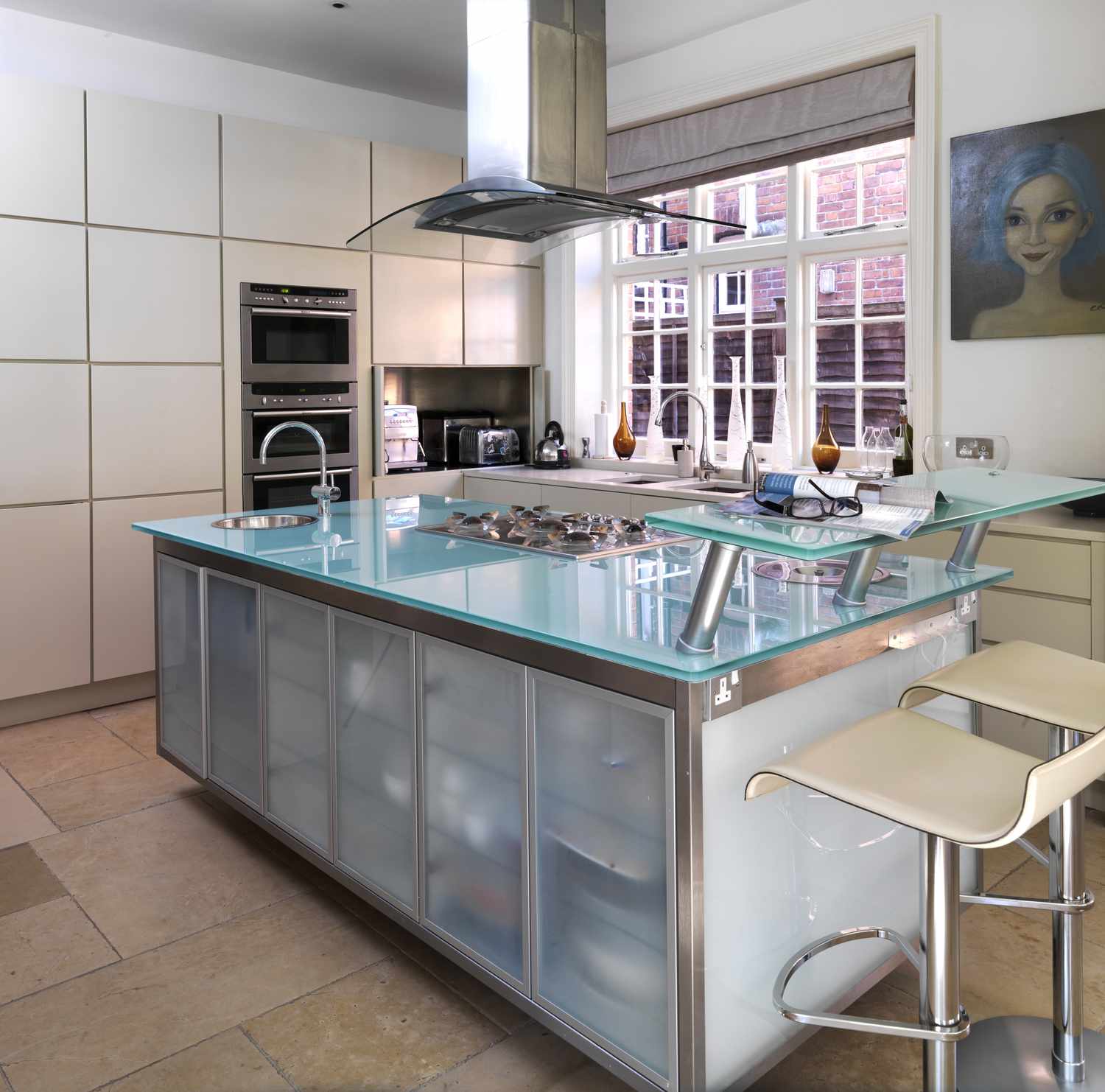 Bar stools at breakfast bar in modern kitchen, UK home