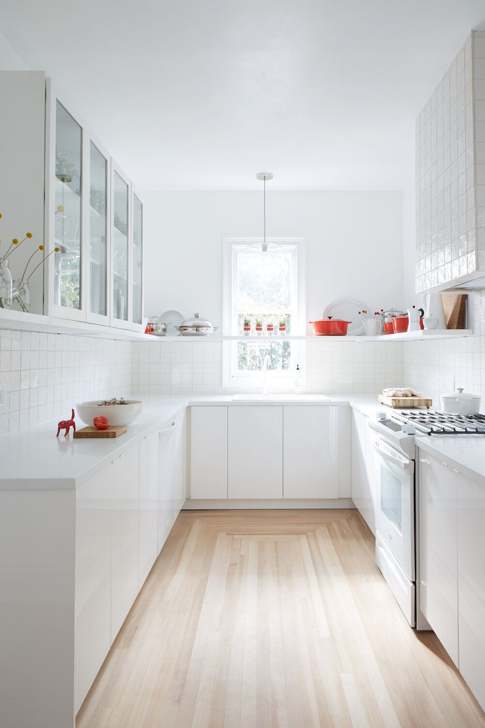 clear glass pendant light over kitchen sink