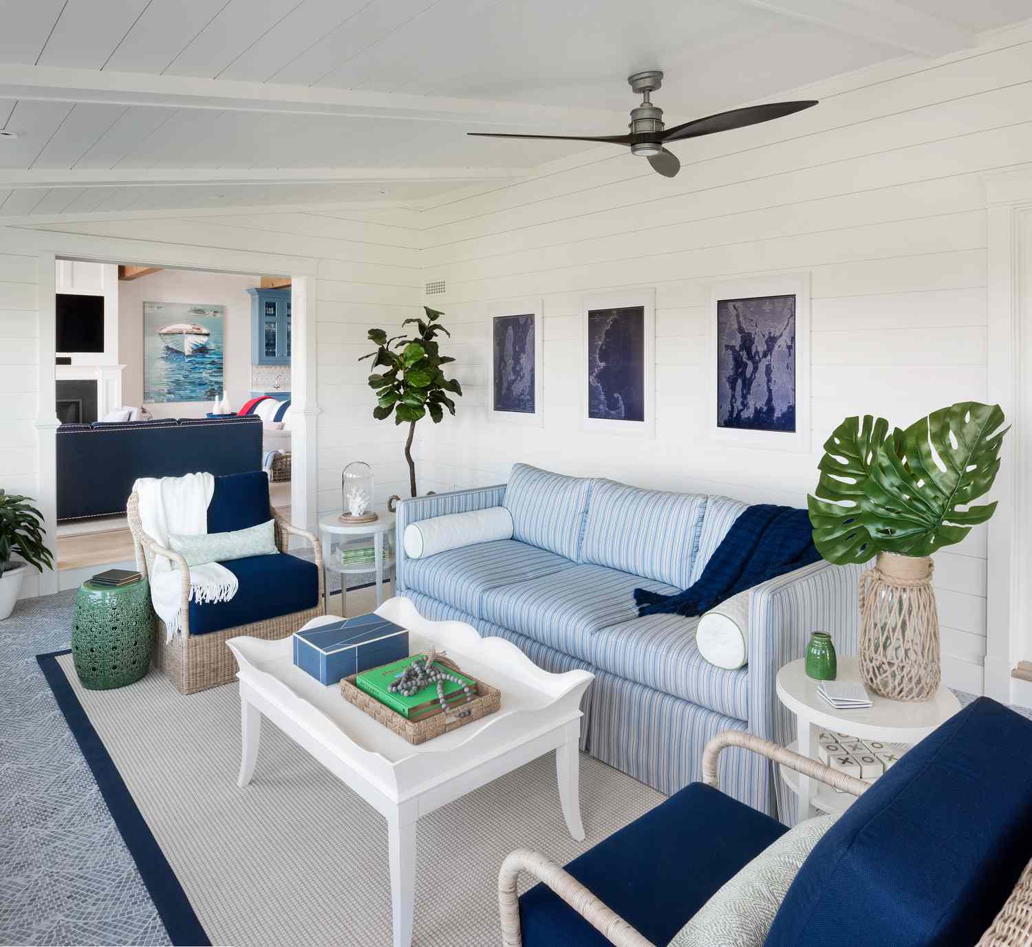 Sunroom with blue and white furniture and fresh greenery