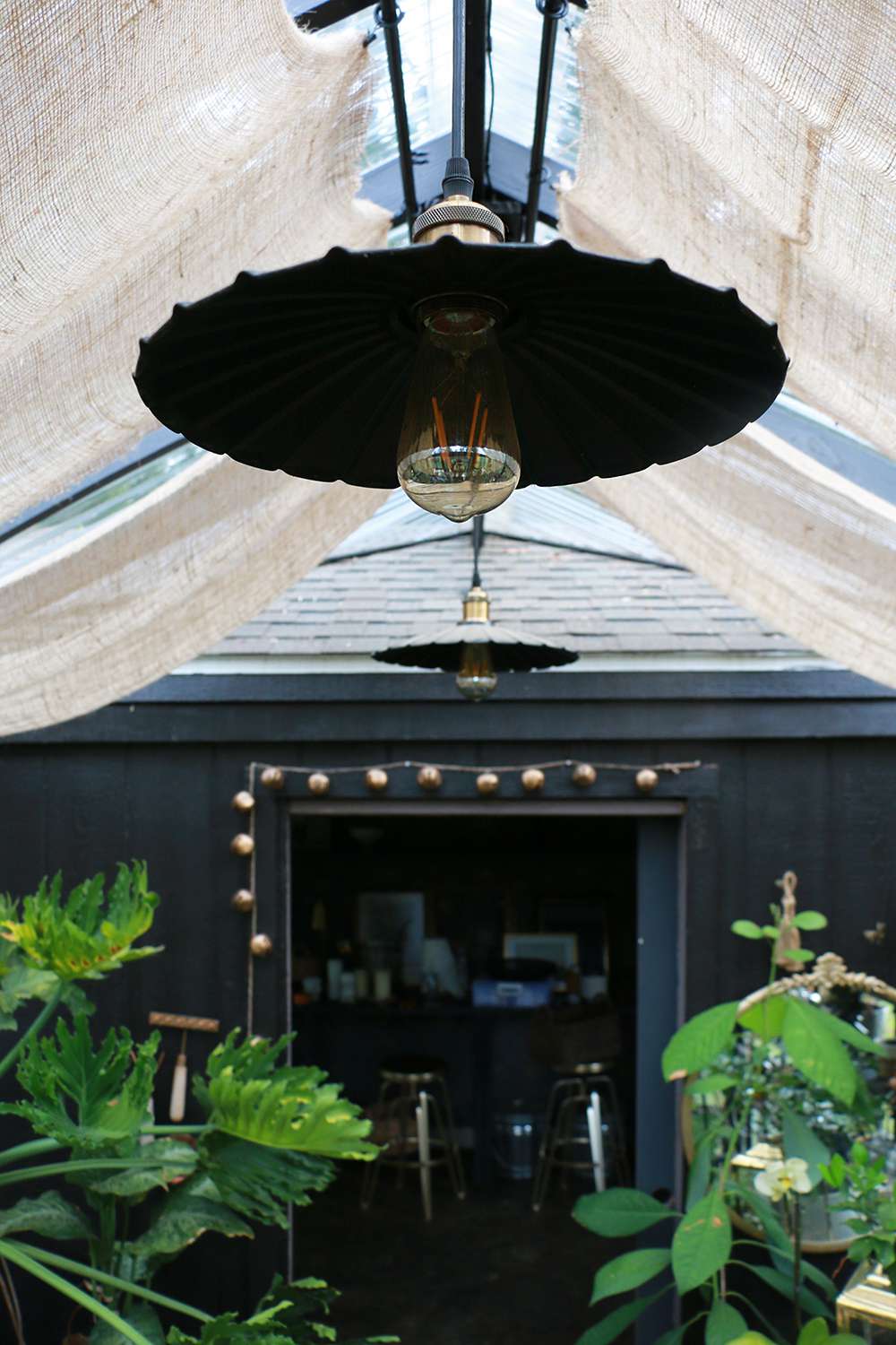 Black metal light fixture hanging from the ceiling