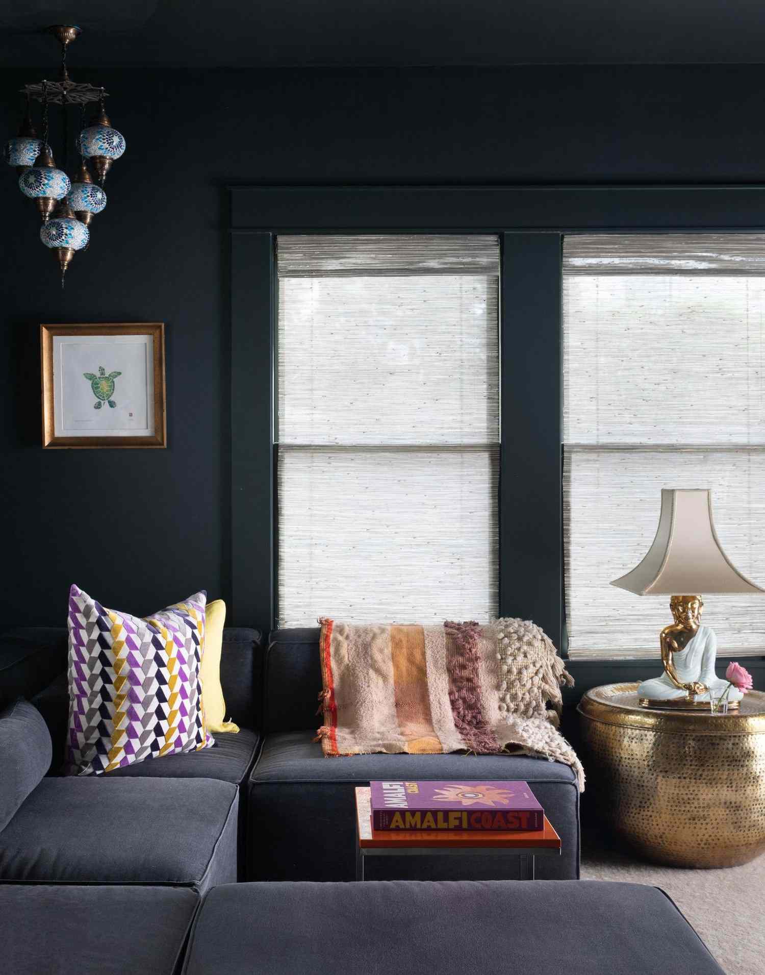 Small sunroom color-drenched in a dark paint color with eclectic furnishings and decor