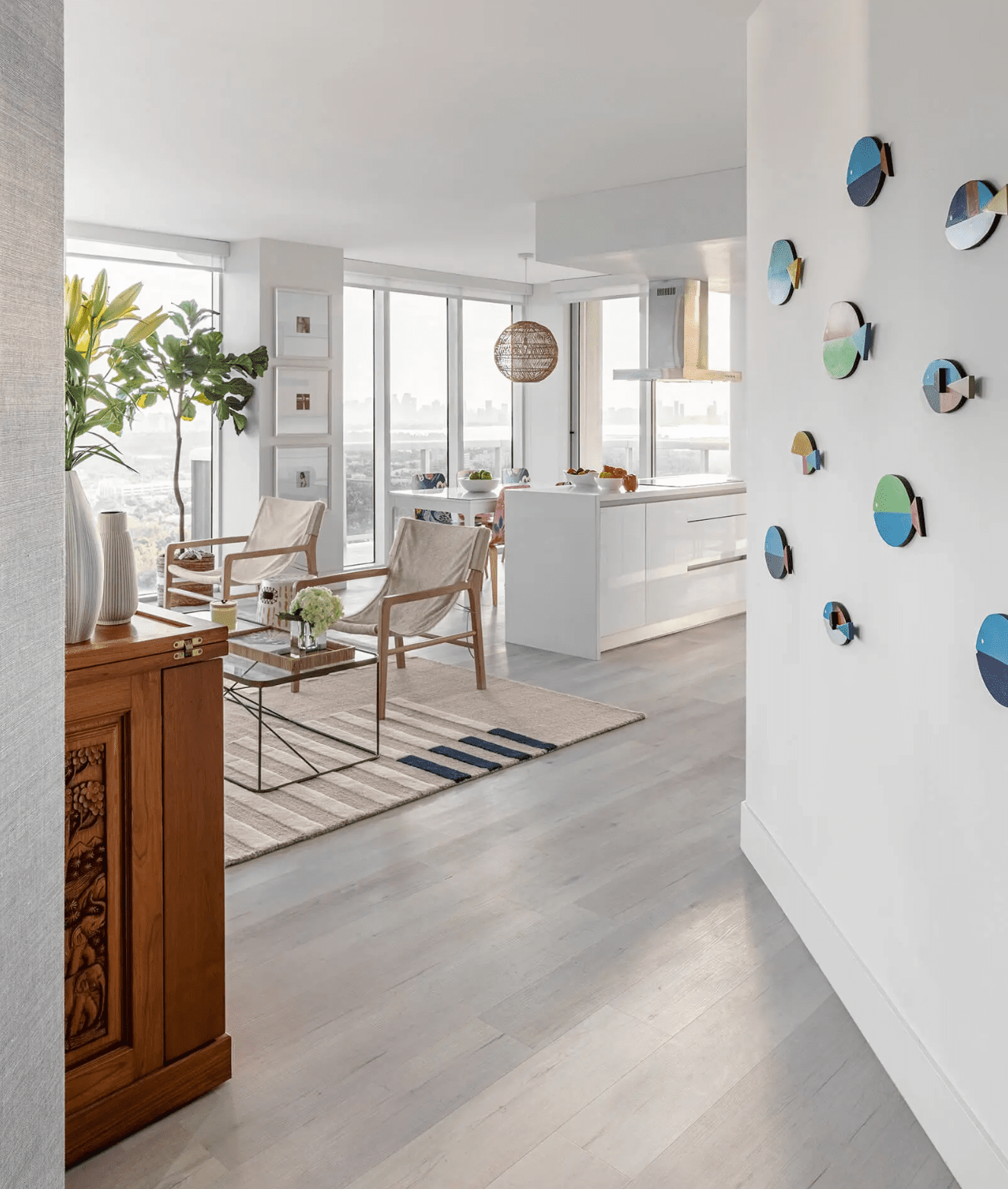 Kitchen and living room in an open space with floor to ceiling windows