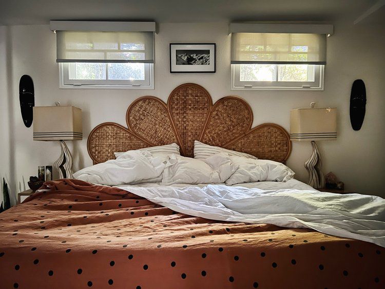 vintage rattan wall-mounted headboard over bed