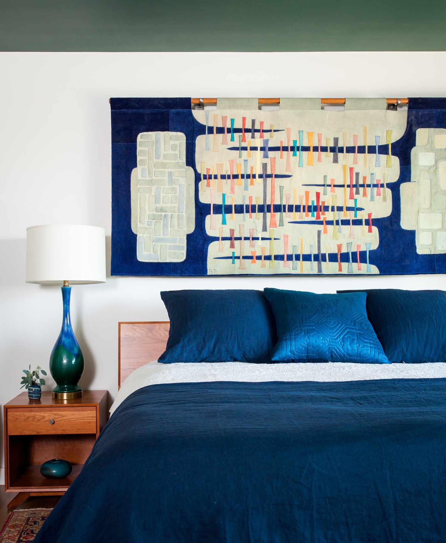 decorating with a textile wall hanging over the bed