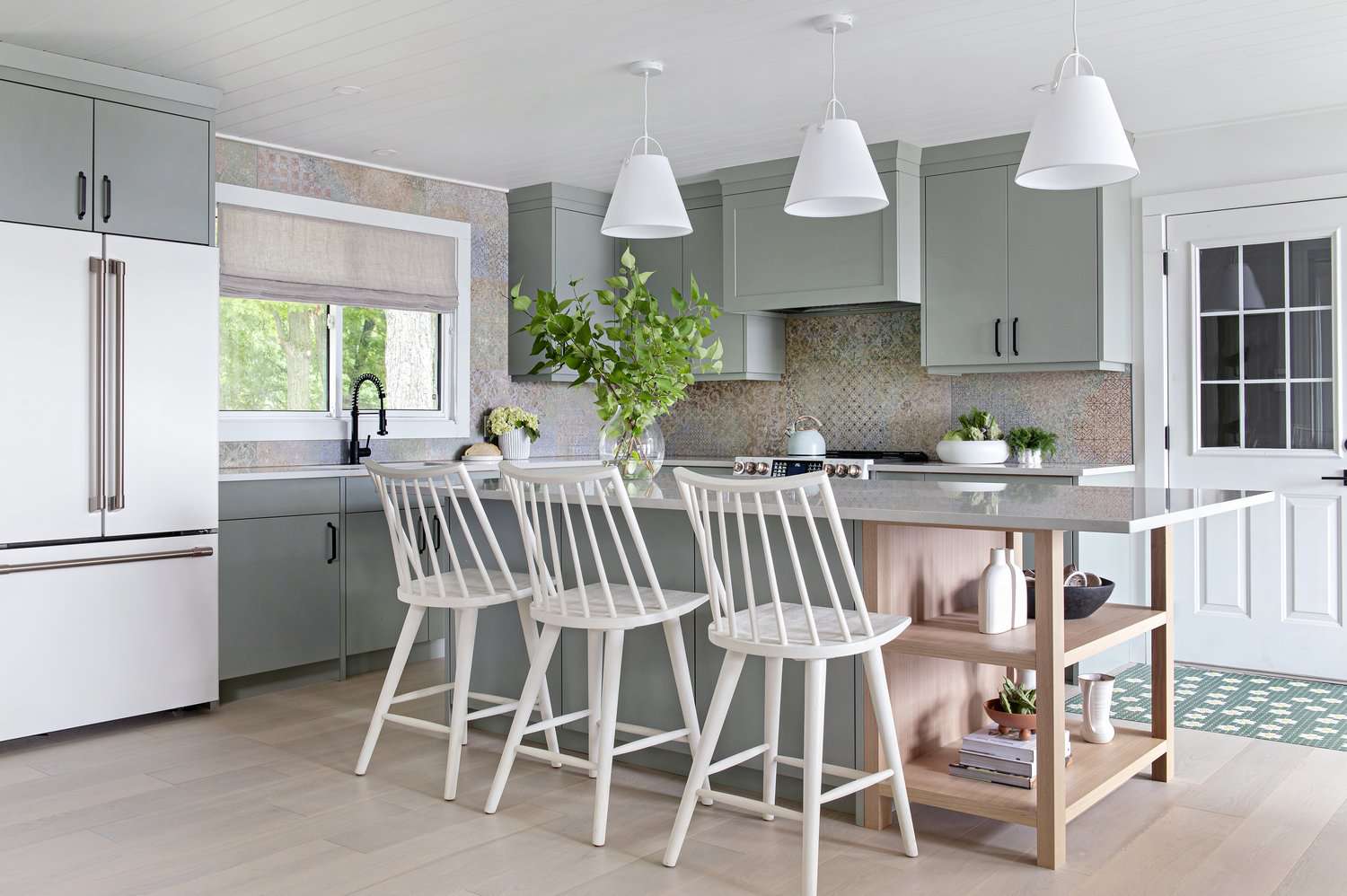 small cottage kitchen with trio of pendant lights over island